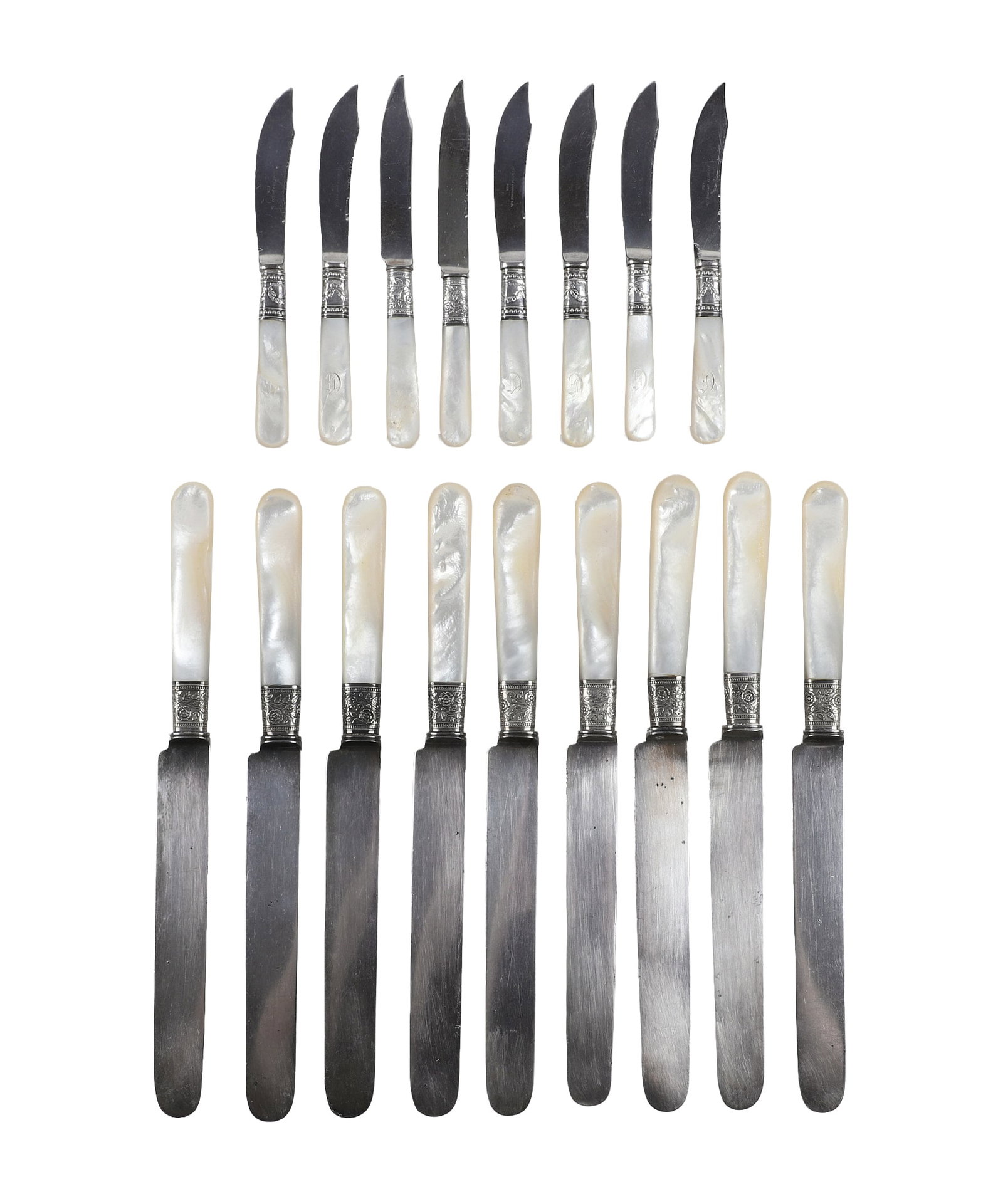 Two Sets of Vintage Mother of Pearl Handled Cutlery.: Two Sets of Vintage Mother of Pearl Handled Cutlery. Vintage Mother of Pearl Handled Cutlery with silver ferules to include a set of 9 dinner knives, with floral designs, unmarked, 10" L. and a set