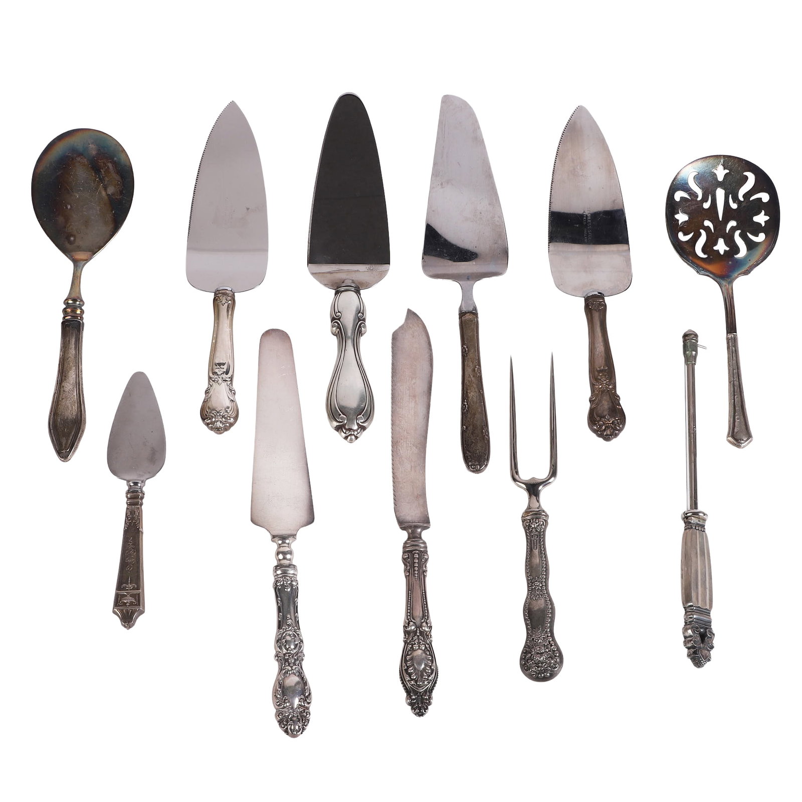 (11) Silver Hollowware Utensils: (11) Silver Hollowware Utensils (11) Silver hollowware utensils with the majority being pieces with sterling handled pie servers, meat servers, cheese slicers & more. No weighable sterling.