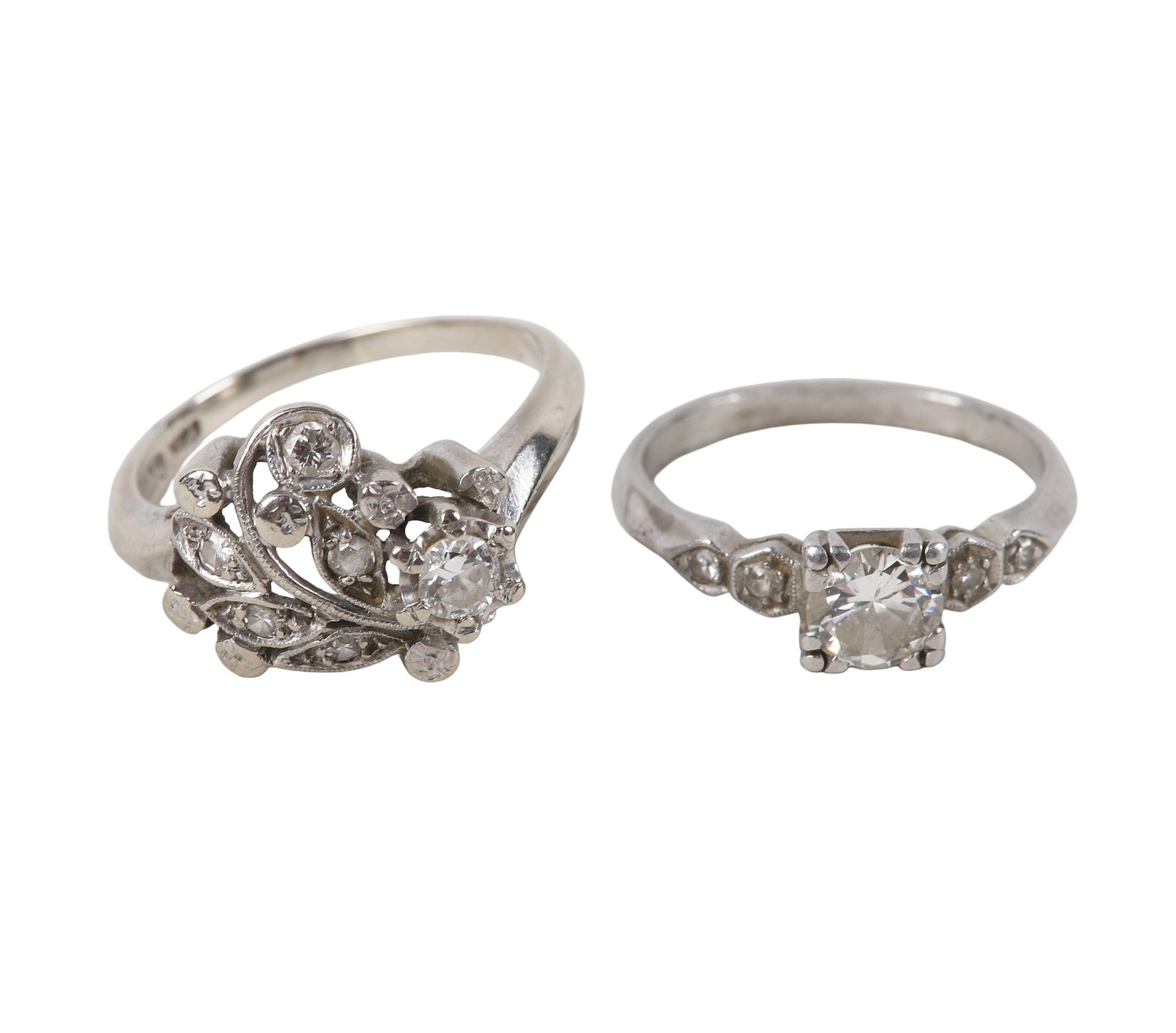 (2) 14K White Gold Diamond Rings: (2) 14K White Gold Diamond Rings (2) 14K White Gold Rings including a round cut center diamond flanked by 2 accent diamonds, size 6.5, and a round cut center diamond in an openwork floral design