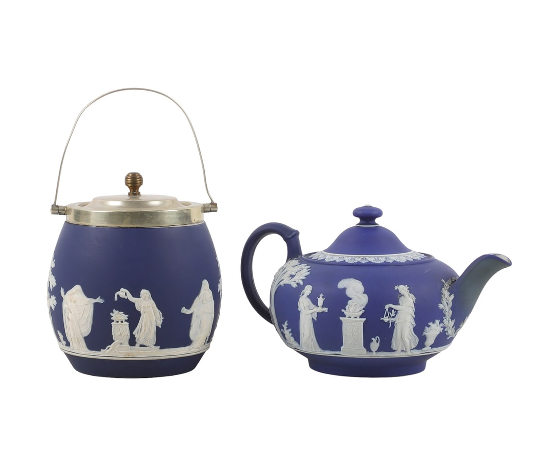 (2) Wedgwood Blue Jasperware Biscuit Jar & Teapot.: (2) Wedgwood Blue Jasperware Biscuit Jar & Teapot. Fine Wedgwood blue jasperware to include a teapot, 9 1/2"L x 5 1/2"H, and biscuit jar with silver plated lid & handle, 5 3/4"W x 6 1/2"H. Makers mark