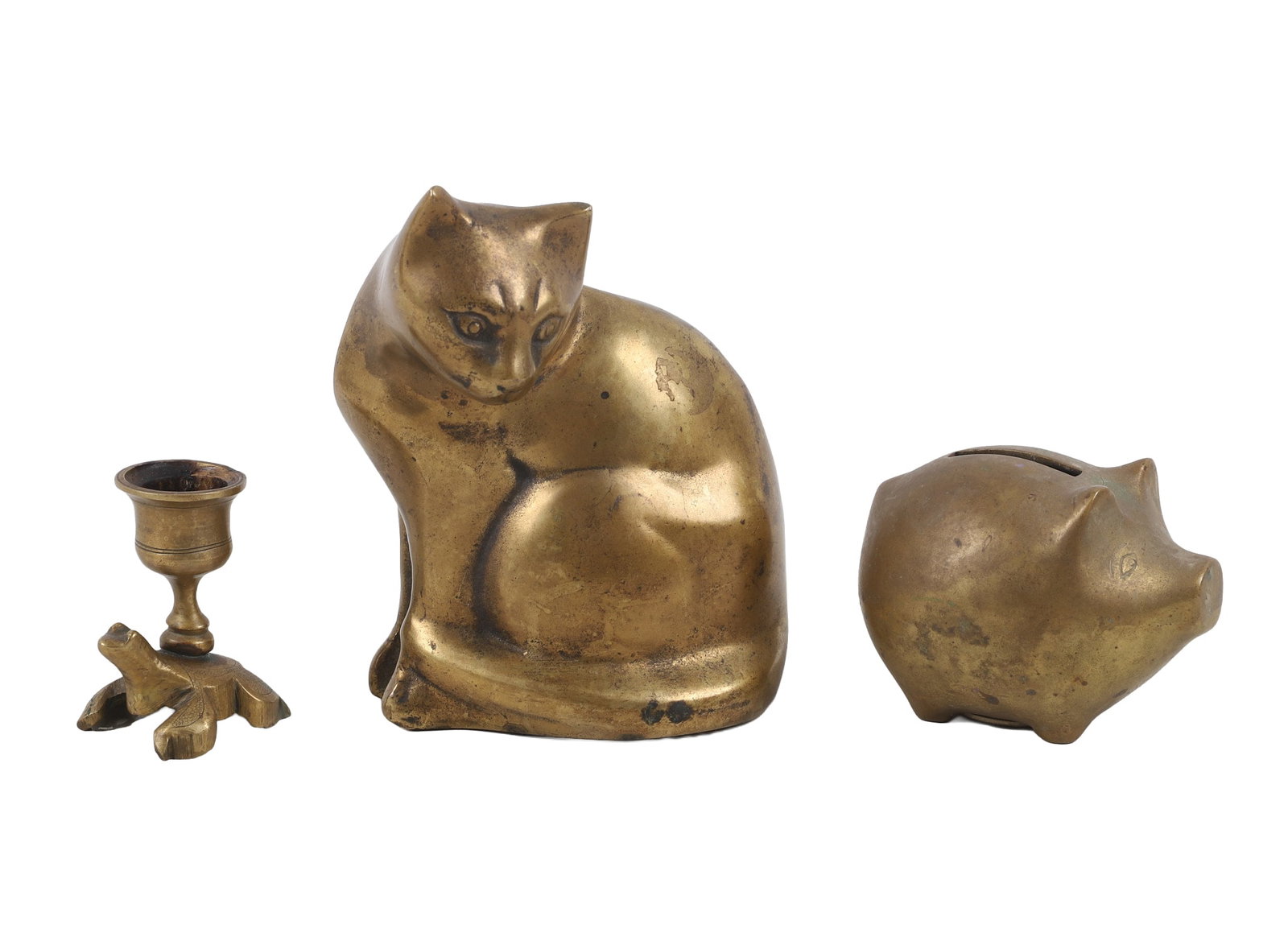 (3) Brass Animals: (3) Brass Animals Brass animals featuring a 5 1/2"H x 4 1/2"W x 4"D figure of a sitting cat. Also includes a small piggy bank and a frog candlestick.