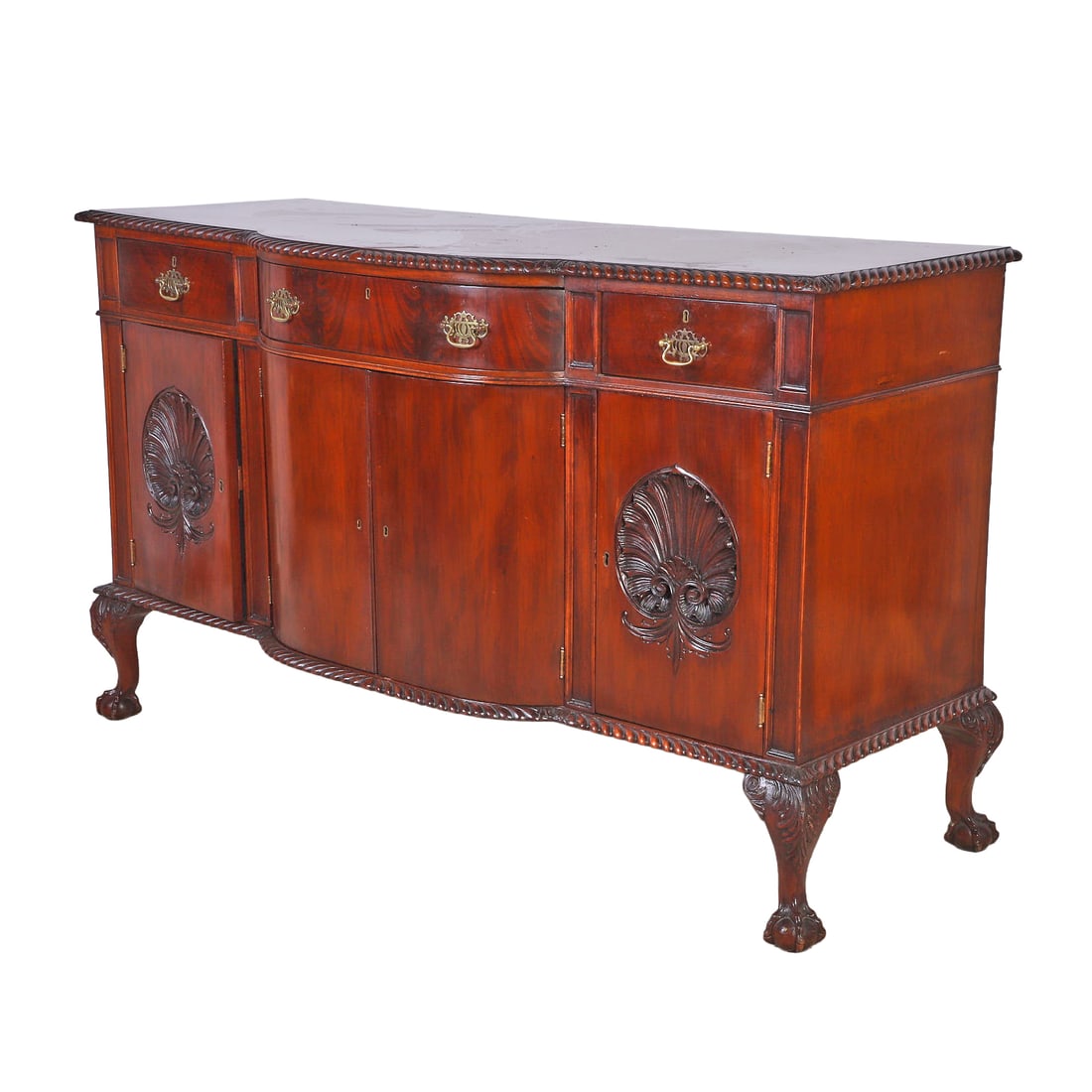 Chippendale Style Mahogany & Oak Sideboard, Early 20th C.: Chippendale Style Mahogany & Oak Sideboard, Early 20th C. The serpentine case with fully gadrooned top and skirt, 3 drawers over 4 doors - two with shell carvings, all supported by carved ball and