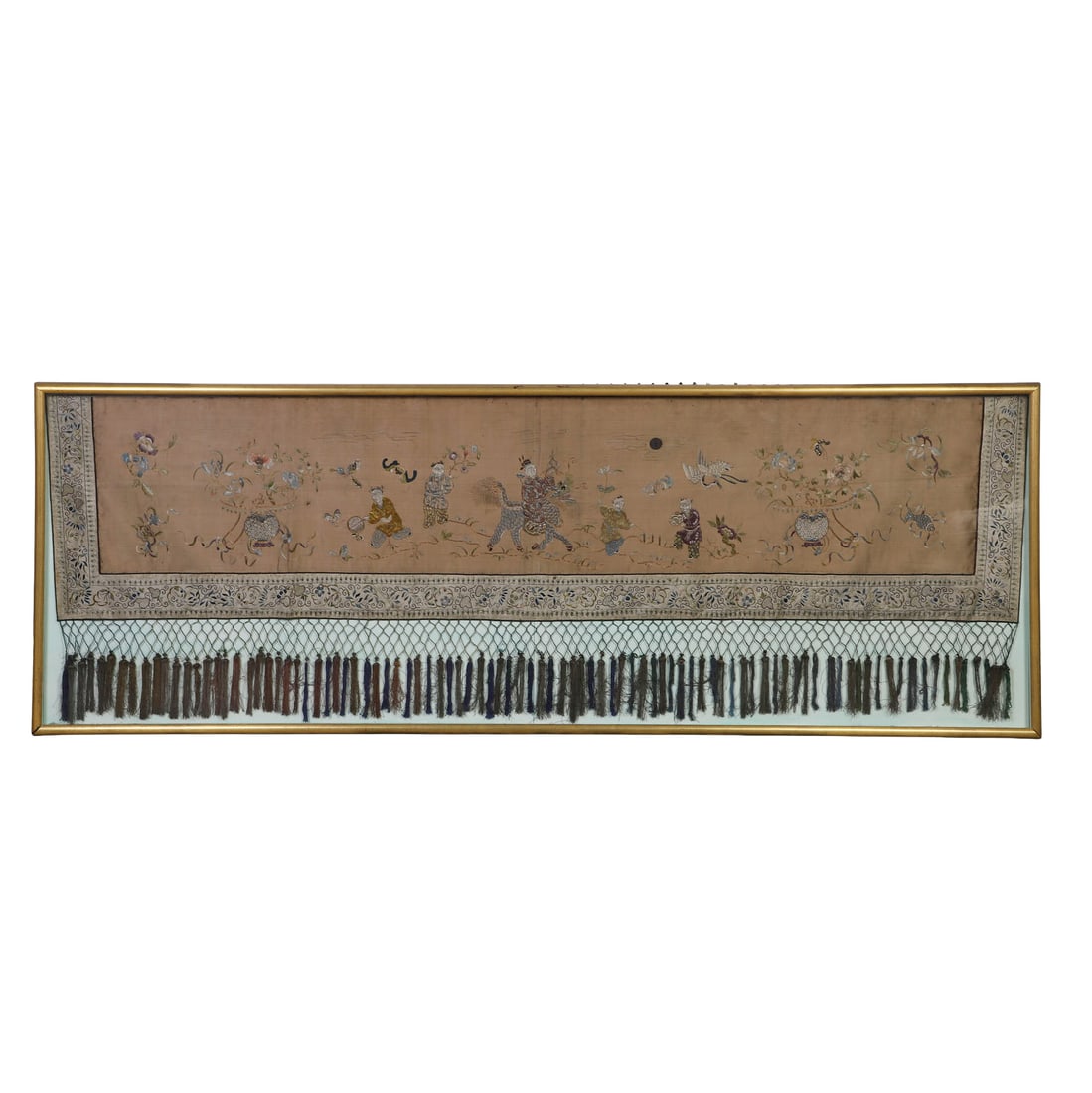 Antique Chinese Kesi Tapestry Textile Trapping: Silk embroidered panel with courtesan scenes bordered by a narrow floral band and fringed with a reticulated net terminating in tassels. Mounted and framed under glass in a giltwood frame. 25" H x