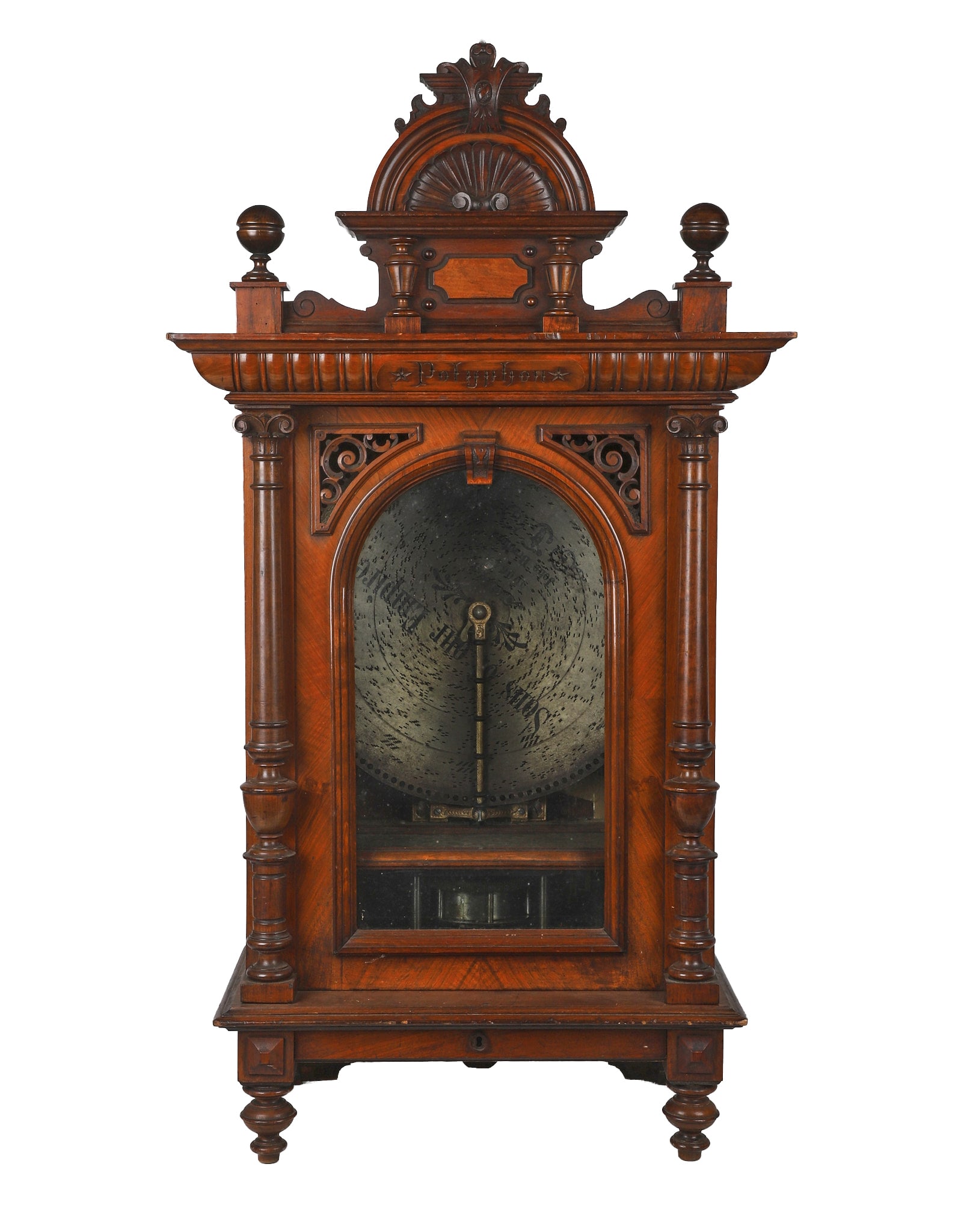 Polyphon 19 5/8" Upright Disc Music Box, Early 20th C.: German Polyphon upright disc music box, early 20th C.. plays 19 5/8" discs, housed in a walnut cabinet with carved Polyphon nameplate, turned columns, arched glazed door, applied scrollwork and an