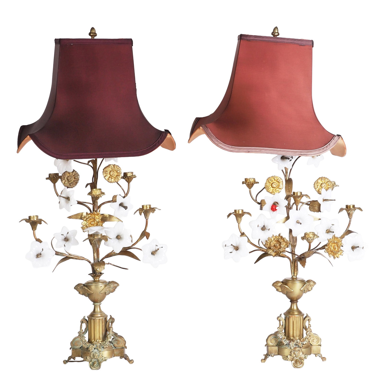 Pair of Gilt Bronze Candelabra Lamps: Intricately decorated pair of gilt bronze candelabra lamps accented with opaline florals. Footed base decorated with garlands and cherubs, each lamp fitted with six spots for candles in addition to