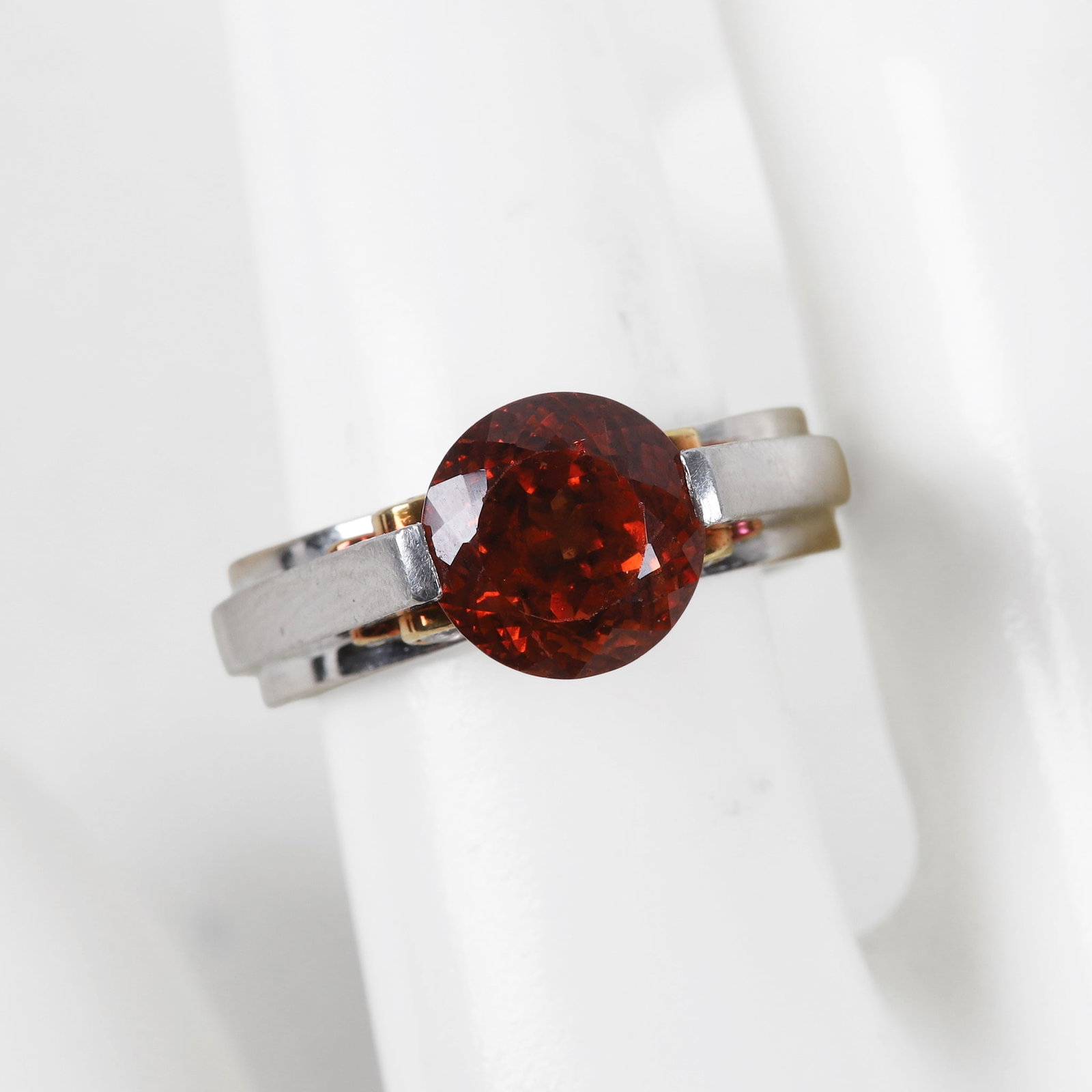 Platinum Round Cut Mandarin Garnet & Diamond Ring: Platinum Round Mandarin Garnet & Diamond Ring, accented by 8 bezel set round cut diamonds, 4 on each side, interior of ring marked PLAT, size 8,center stone approximately 4ct.