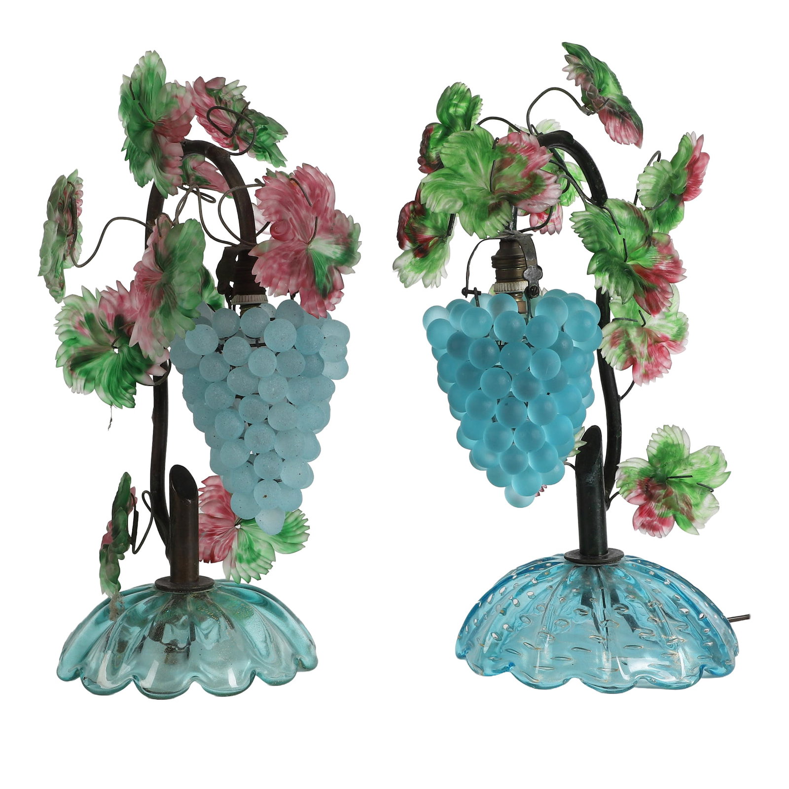 Pair of Italian Murano Style Art Glass Grape Table Lamps: Pair of Art Deco Italian Murano style art glass figural table lamps with leafy vine stems and beaded grape shade, matching aside from individually unique glass bases. Each 16"H x 7 1/4"W x 9 1/2"D, no