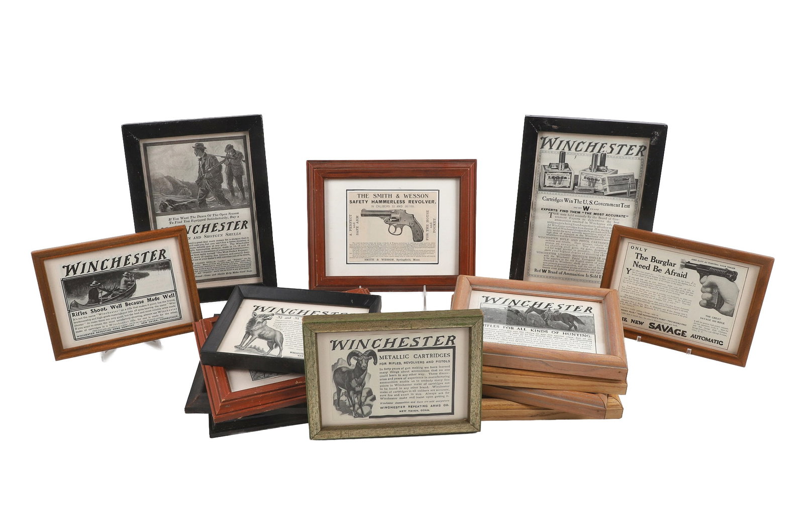 (14) Framed Advertisements Feat. Firearms: (14) Lot of framed turn of the century advertisements dealing with firearms, particularly Winchester rifles but also including Smith & Wesson, Savage and Iver Johnson. Largest frame 10 1/4" x 7 1/2"