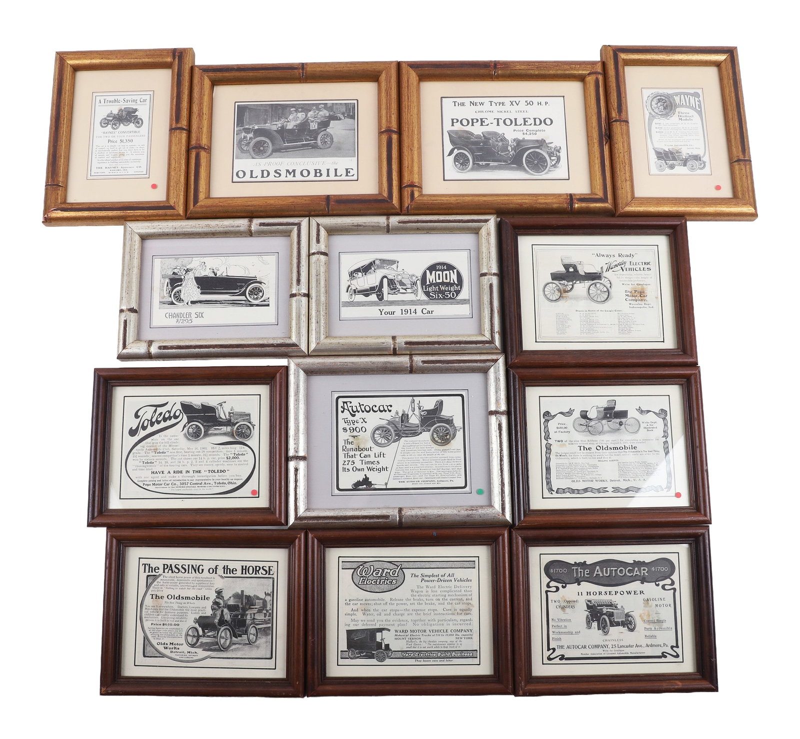(13) Framed Advertisements Feat. Automobiles: (13) Lot of framed turn of the century advertisements dealing with automobiles, particularly Oldsmobile but also including some early electric vehicles and other bygone manufacturers. Largest frame 9 