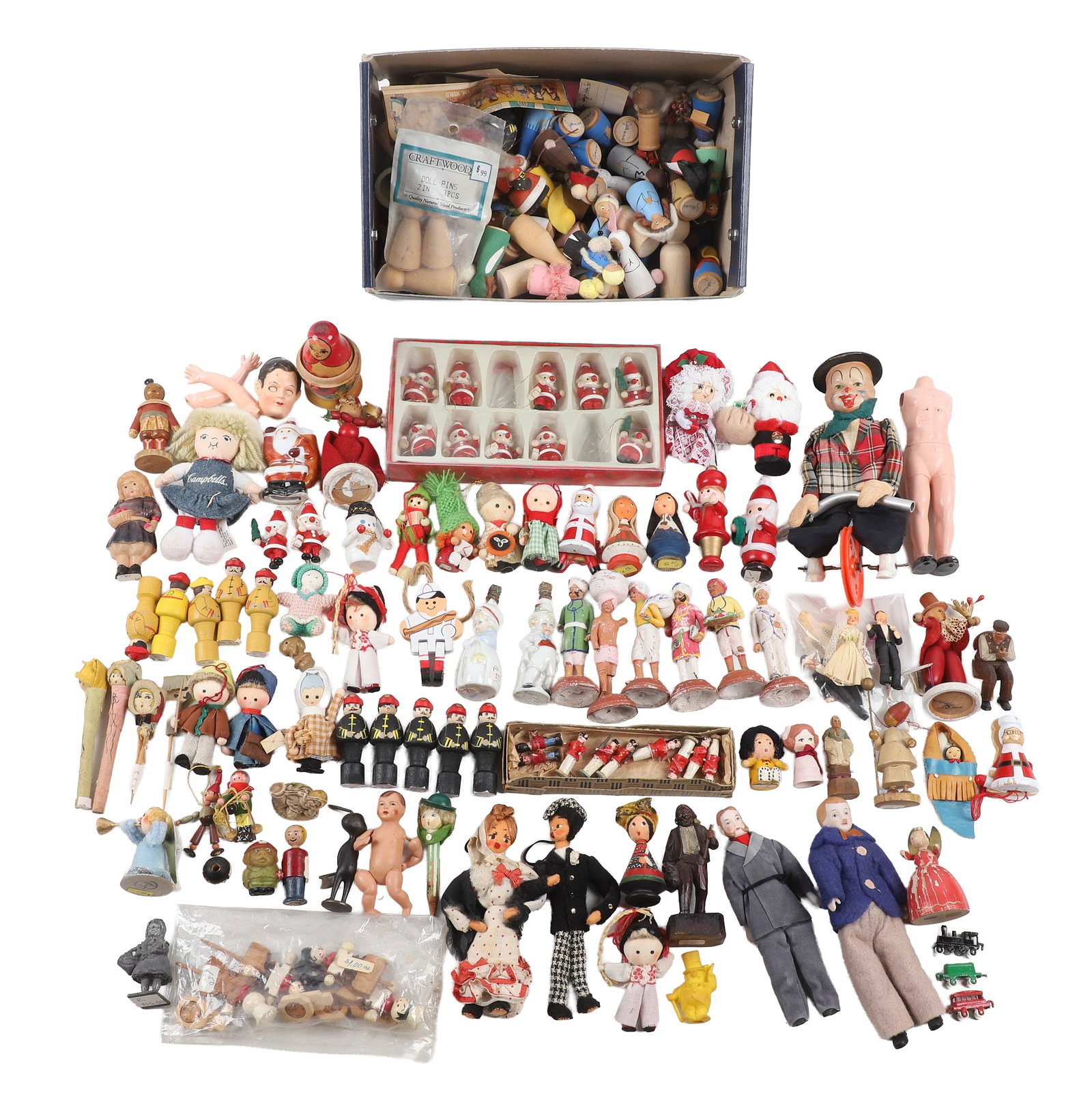 Collection of Figural Toys & Miniatures: Collection of figural toys & miniatures including a 7 1/2"H unicyclist, bisque dolls, die cast figures, a large assortment of painted and unpainted wooden doll pegs and much more.