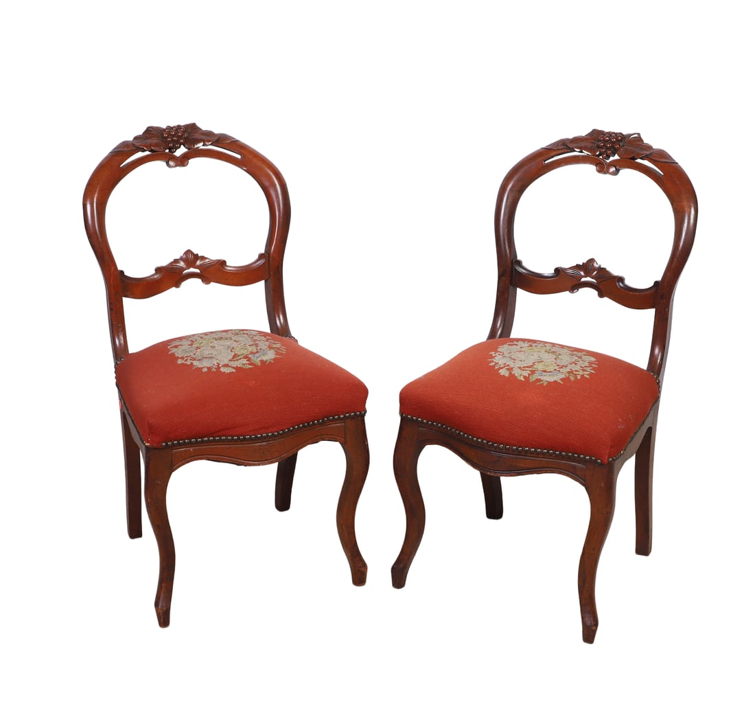 Antique Victorian Balloon Back Side Chairs: Antique Victorian Balloon Back Side Chairs Carved mahogany frames with grapevine motif yoke. Floral bouquet needlepoints seats. Size: 34.25" H x 17.75" W x 23" D.