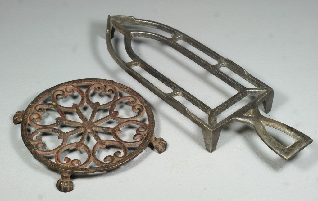 2 cast metal trivets, largest measuring 12" long: 2 cast metal trivets, largest measuring 12" long