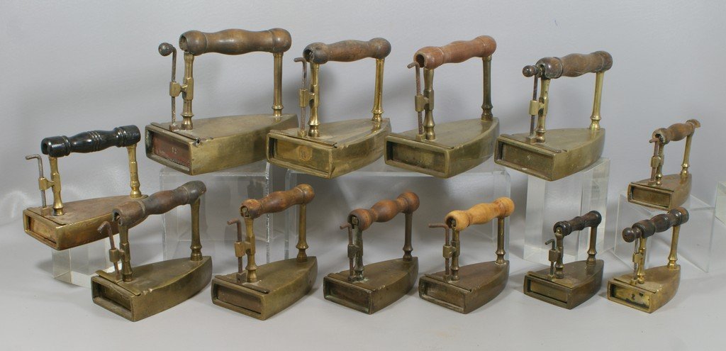 Matched set of 12 brass slug irons, from #1 through: Matched set of 12 brass slug irons, from #1 through #12, assembled lot, many with slugs, largest 9" long, smallest 4-1/2" long