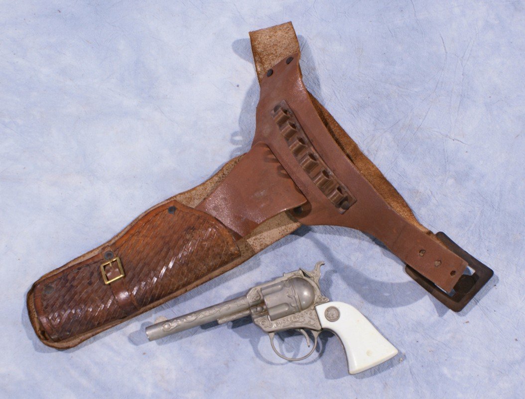 Leather holster with cap gun marked Buckaroo, gun 7: Leather holster with cap gun marked Buckaroo, gun 7 3/4" long