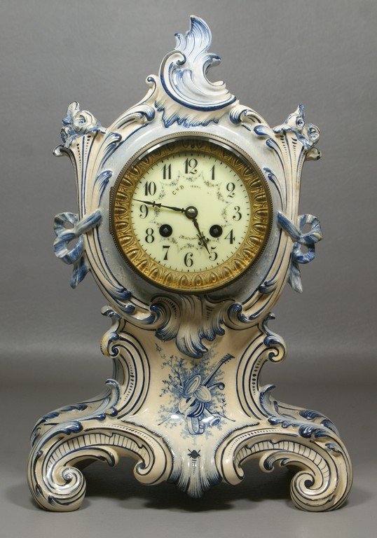Louis XV rococo style china case clock with blue floral: Louis XV rococo style china case clock with blue floral decoration, J Marti French movement, porcelain dial with CY Davidson, Baltimore retailers mark, dial in excellent condition, 14 3/4" tall, runs 