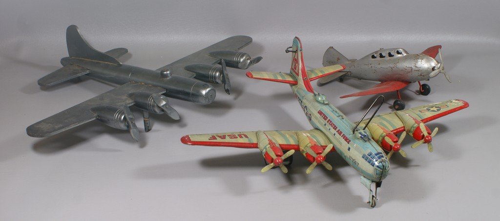 3 Airplanes to include a Japanese Tin Lithograph USAF: 3 Airplanes to include a Japanese Tin Lithograph USAF Plane with 4 props by ET Co, one silver and red metal plane, no marks, and one handmade wooden silver painted plane, largest 21" wide