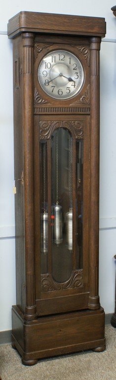 Carved oak German hall clock, 3 pull chain weights,: Carved oak German hall clock, 3 pull chain weights, beveled glass in door, 84" h