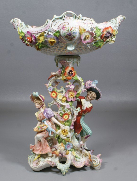 Sitzendorf 2 part porcelain figural compote pierced: Sitzendorf 2 part porcelain figural compote pierced basket and base with floral and bird decoration with figures of man and woman, some losses to flower petals, 13" tall