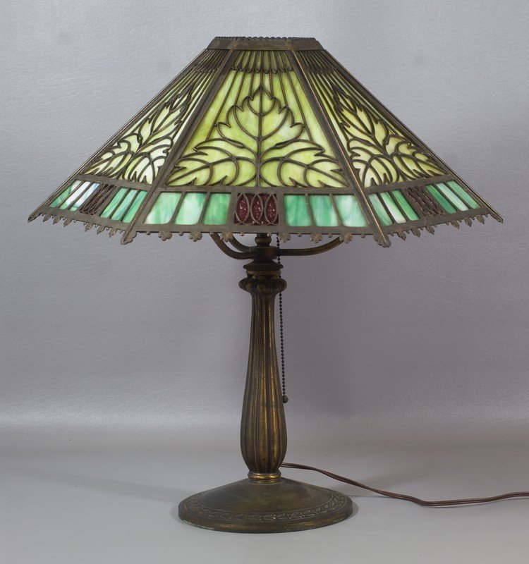 Bradley & Hubbard patinated white metal art deco table: Bradley & Hubbard patinated white metal art deco table lamp with married Bradley & Hubbard filigree overlay green and red slag glass art deco 6 panel shade, 22" h, 17 3/4" d, signed shade and base, nu