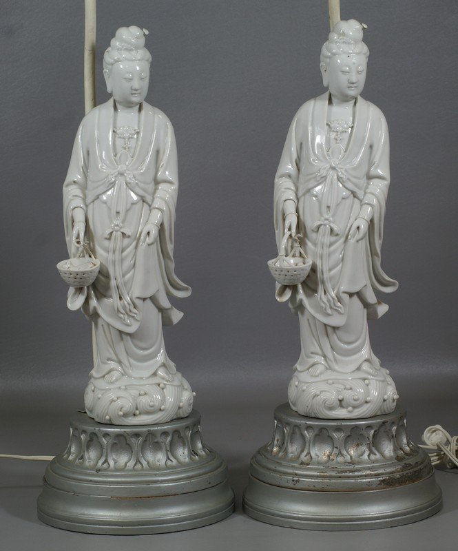 Pair of Blanc de Chine figures of Guanyin, mounted as: Pair of Blanc de Chine figures of Guanyin, mounted as lamps, figures approx 14-1/2" high, front half of one basket handle missing, bases filled with plaster, no other damage noted