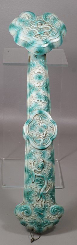 Chinese porcelain scepter with jade green and ivory: Chinese porcelain scepter with jade green and ivory colored glaze on bat and dragon pursuing pearl relief decoration, staple repair, 19" long
