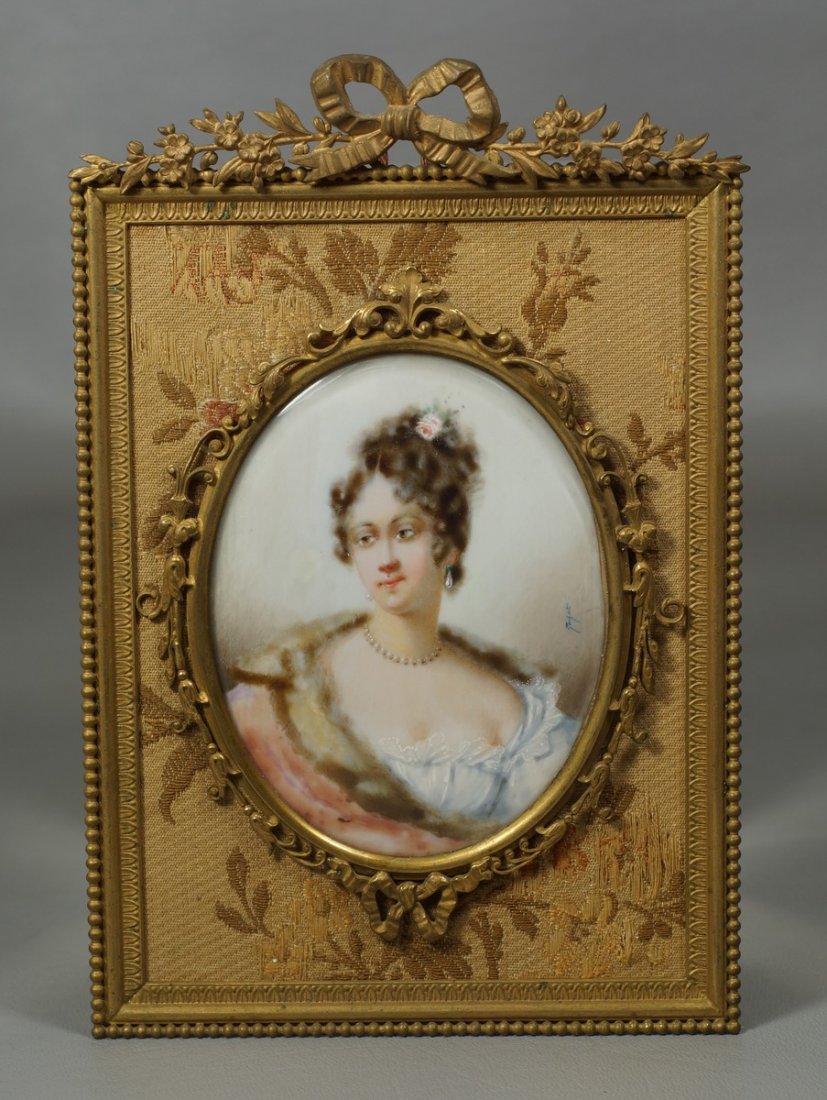 Portrait on ivory of a young woman in ormolu frame,: Portrait on ivory of a young woman in ormolu frame, signed illegibly, missing easel stand, 7" high We adhere strictly to all state and Federal laws pertaining to the sale, shipping, and export of any