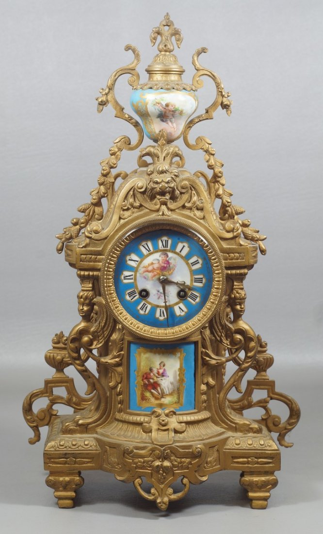 French Style Gilt Metal Mantle Clock, retailed by: French Style Gilt Metal Mantle Clock, retailed by Bailey Banks and Biddle, porcelain urn with painted cherub on top, porcelain painted dial with cherub, porcelain plaque to base, 19" high