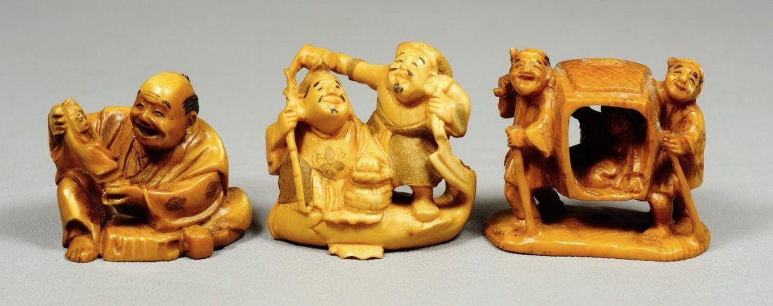(3) tea stained carved ivory Japanese netsuke, man: (3) tea stained carved ivory Japanese netsuke, man holding doll, 2 men carrying sedan chair, 2 men on a fish, all signed, tallest 1 3/8". We adhere strictly to all state and Federal laws pertaining to