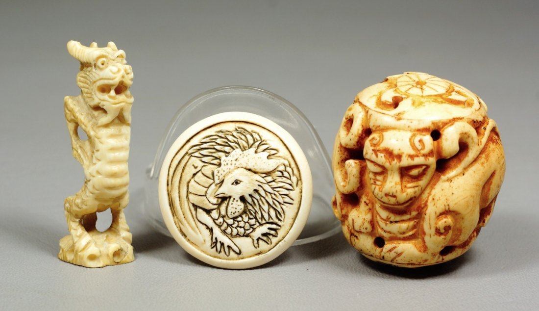 (3) carved ivory Japanese netsuke, disc with dragon,: (3) carved ivory Japanese netsuke, disc with dragon, standing dragon, foo dog ball, two signed, tallest 1 3/4". We adhere strictly to all state and Federal laws pertaining to the sale, shipping, and e
