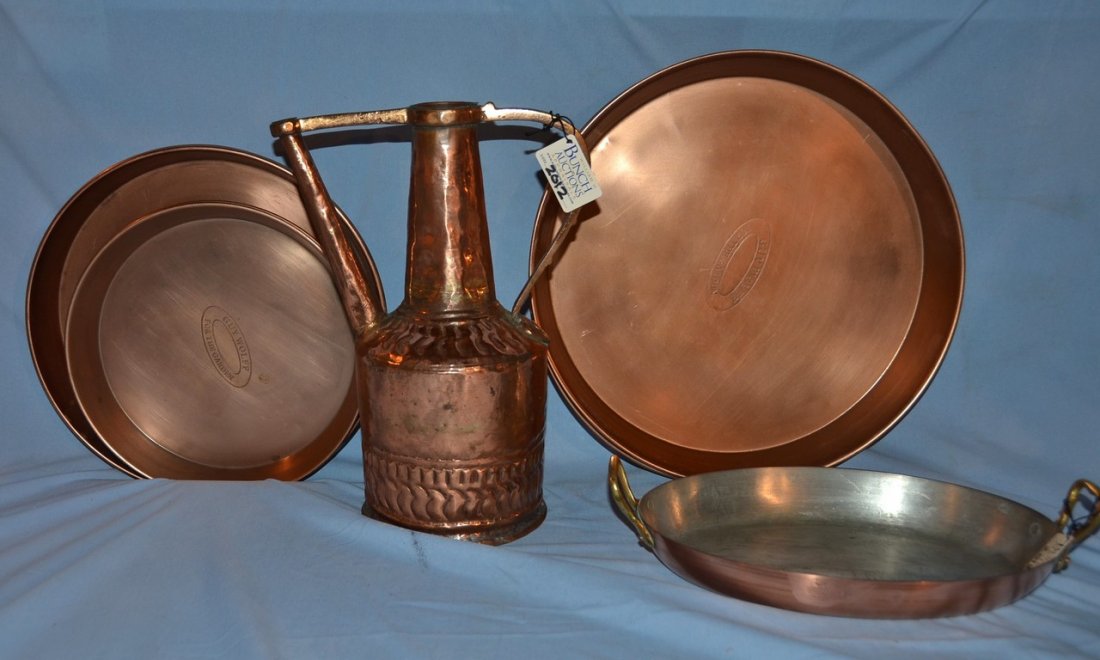 12 pieces of copper, including a ewer, a baking dish,: 12 pieces of copper, including a ewer, a baking dish, and 10 pans by Guy Wolff.