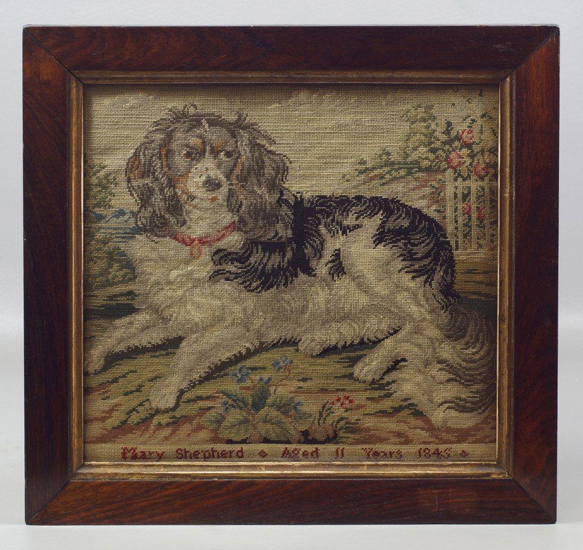 Needlepoint panel depicting King Charles spaniel: Needlepoint panel depicting King Charles spaniel reclining, signed and dated, Mary Shepherd, Aged 11 years, 1845, in a period rosewood veneer frame, 15 1/2"x 16 1/2" overall