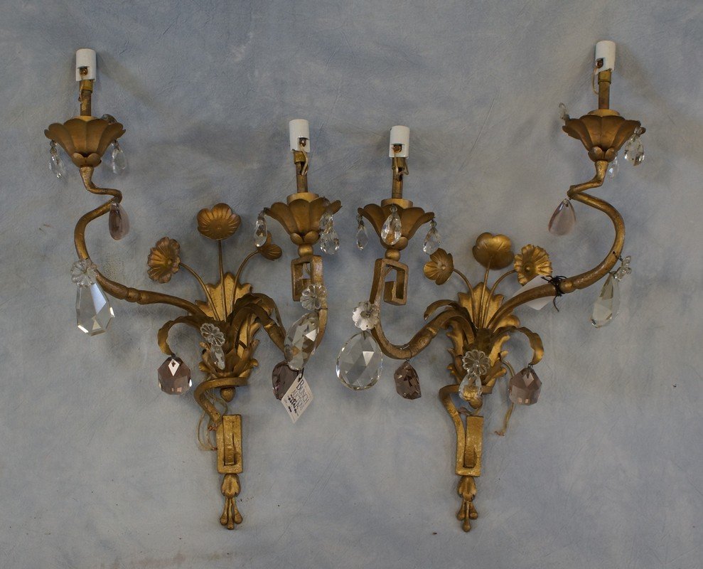 Pair of brass finished metal double arm wall sconces: Pair of brass finished metal double arm wall sconces with hanging prisms, 18" h