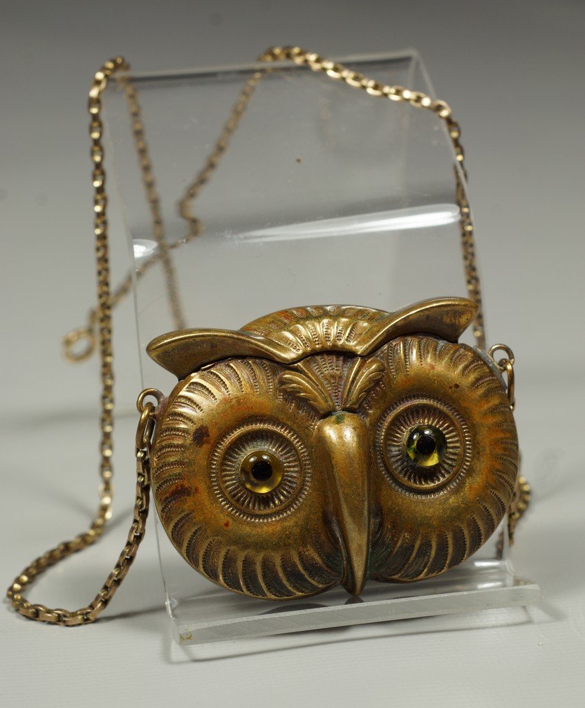 Brass owl head match safe, hinged spring loaded lid,: Brass owl head match safe, hinged spring loaded lid, glass eyes, striker to base, on a YGF chain, 2" w, 1 5/8" h, 3/4" d, unsigned