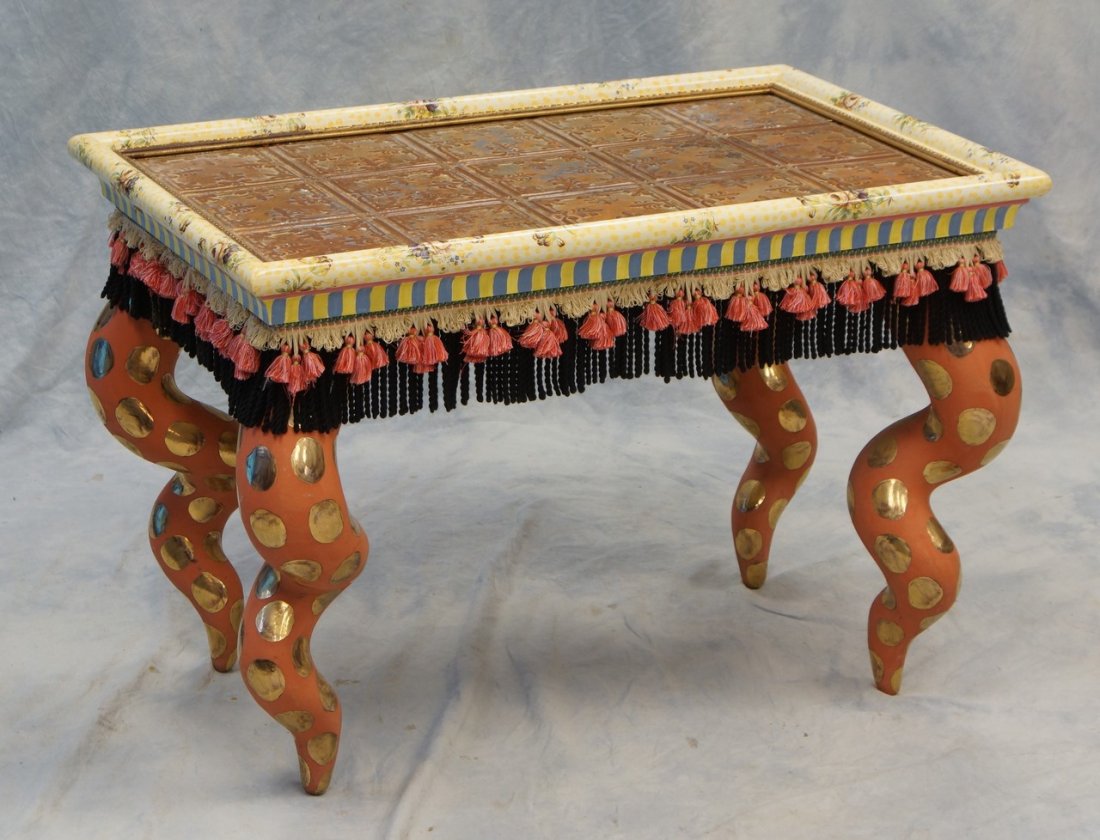 Carved and painted MacKenzie Childs cocktail table,: Carved and painted MacKenzie Childs cocktail table, signed and dated 1983, embossed sheet metal top, cork screw legs, fringed apron, 34" x 21 1/2", 23" h
