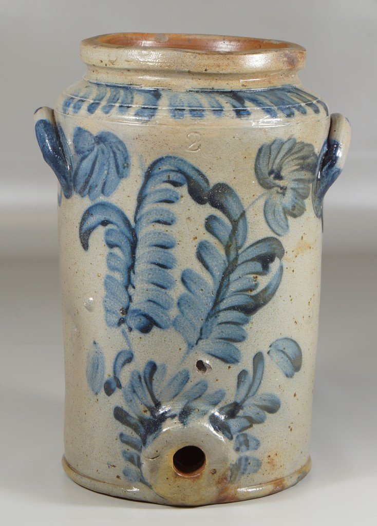 Manner of Robert Remmey, 2 gallon stoneware blue: Manner of Robert Remmey, 2 gallon stoneware blue decorated water cooler, unsigned impressed 2 at top, extensive blue fern and floral design, glaze hairline below rear of left handle, stone bubbles and