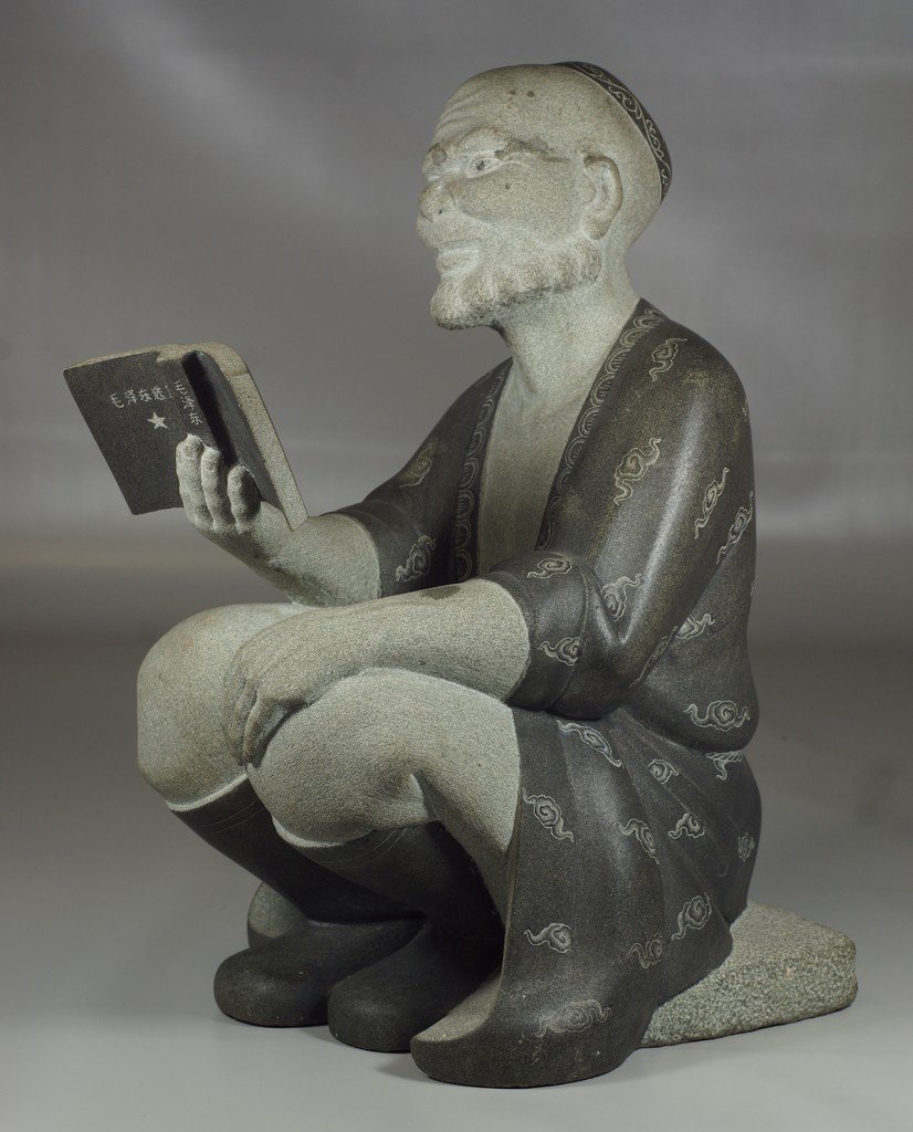 Chinese Cultural Revolution carved stone sculpture of: Chinese Cultural Revolution carved stone sculpture of an old man reading Mao Zedong's works, 17" h 石雕, 维吾尔族老人读毛泽东