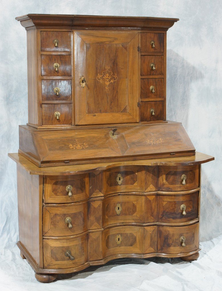 Inlaid Circassian walnut Biedermeier secretary desk,: Inlaid Circassian walnut Biedermeier secretary desk, top section with a floral inlaid central door, concealing an interior with 8 drawers that are locked by a single master lock, the floral inlaid sla
