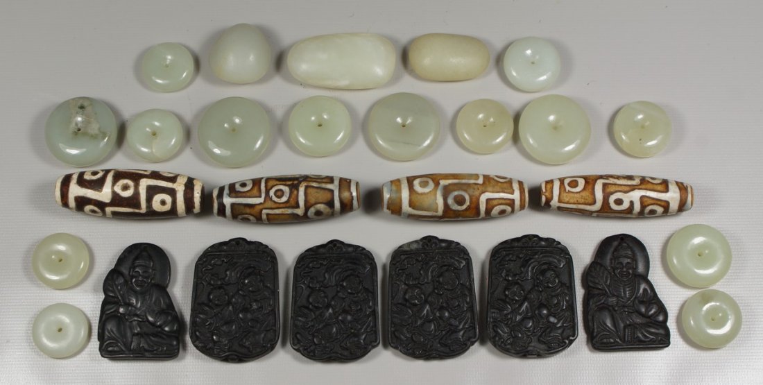 (6) carved black stone amulets, 1 1/4" h, with 14 jade: (6) carved black stone amulets, 1 1/4" h, with 14 jade buttons, largest 1", 3 jade stones, and 4 ceramic elongated beads with geometric decoration, 2" long
