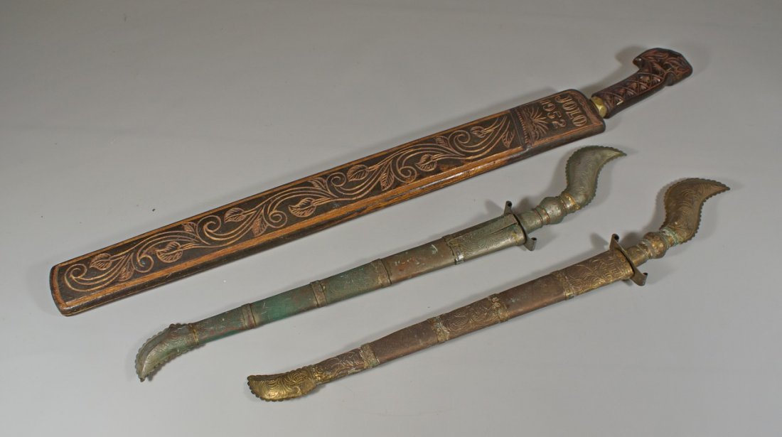 (2) North African knives in metal scabbards, tourist: (2) North African knives in metal scabbards, tourist trade, with a Filipino machete in carved wooden scabbard dated 1952