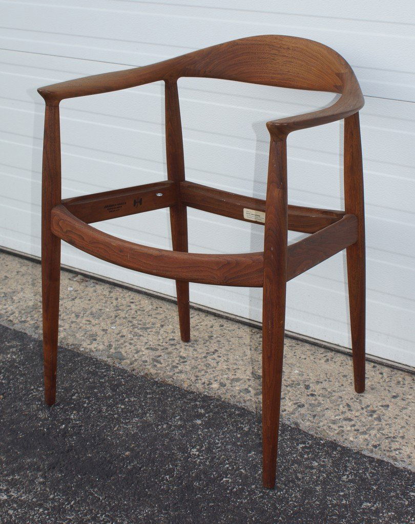 Hans Wegner/Johannes Hansen 'The Chair' arm chair: Hans Wegner/Johannes Hansen 'The Chair' arm chair, designed 1949. Executed in solid teak with continuous arms and slightly splayed tapering legs. Lacking seat cushion. Branded Johannes Hansen, Copenha