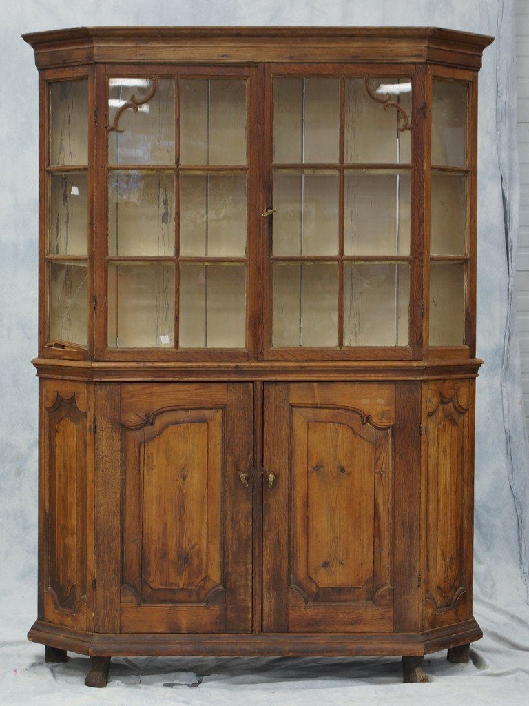 Dutch Pine and Oak side cabinet, 18th century, the: Dutch Pine and Oak side cabinet, 18th century, the upper section with a flat molded cornice above a pair of glazed doors with canted glazed sides, the lower section with a pair of shaped paneled doors