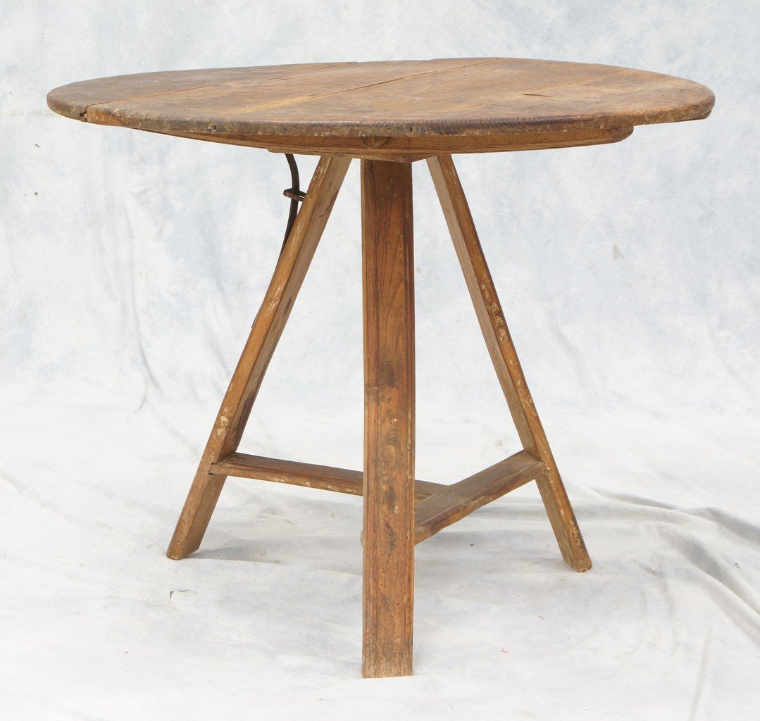 Pine and Fruitwood tilt-top tripod table, 18th century,: Pine and Fruitwood tilt-top tripod table, 18th century, the circular top raised on three slat-molded legs joined by a T-stretcher, 30-1/2" h, 36" diameter
