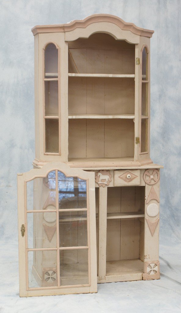 Painted 2-part cupboard, the upper section with shaped: Painted 2-part cupboard, the upper section with shaped arched molded cornice above a glazed door and glazed canted sides, opening to shaped open shelves, the associated lower section with two small dr