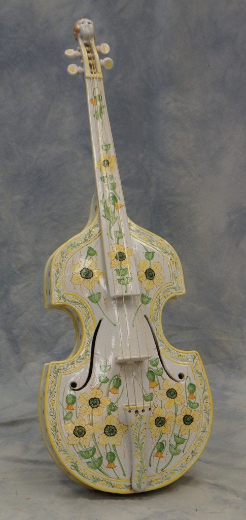 Italian faience cello, green and yellow floral: Italian faience cello, green and yellow floral decoration, brass braided strings, metal easel back, ladies head at top of neck, unmarked, 53" h