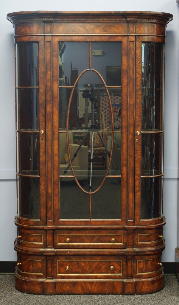 Theodore Alexander Althorp Living History Gothic: Theodore Alexander Althorp Living History Gothic Mahogany Bowfront Library Display Cabinet, the cavetto molded dentil cornice above a plain panel frieze and central oval astragal glazed panel door, fl