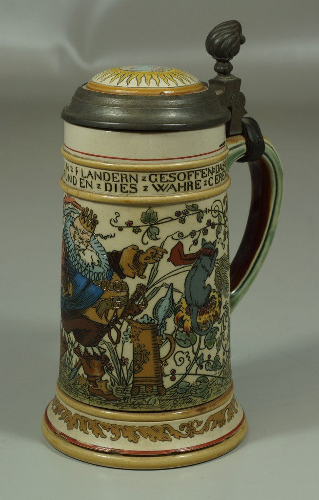 Mettlach 1/2 liter stein #2027, King Gambrinus, the: Mettlach 1/2 liter stein #2027, King Gambrinus, the discoverer of beer, inlay lid, various flakes to raised red rim at base of stein, inside of lid with some staining, tip of thumbrest bent down, othe