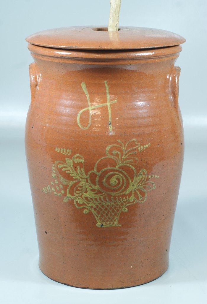 Glazed redware butter churn with lid and dasher, yellow: Glazed redware butter churn with lid and dasher, yellow slip floral basket decoration, probably French, 19th c, 16" tall, 10 1/2" d