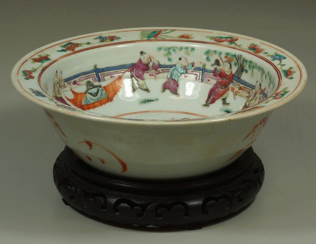 Chinese Export porcelain flanged bowl, interior with: Chinese Export porcelain flanged bowl, interior with figural genre scene, floral and pomegranate border, 11-1/2" d, 3-1/2" h, on a carved hardwood base