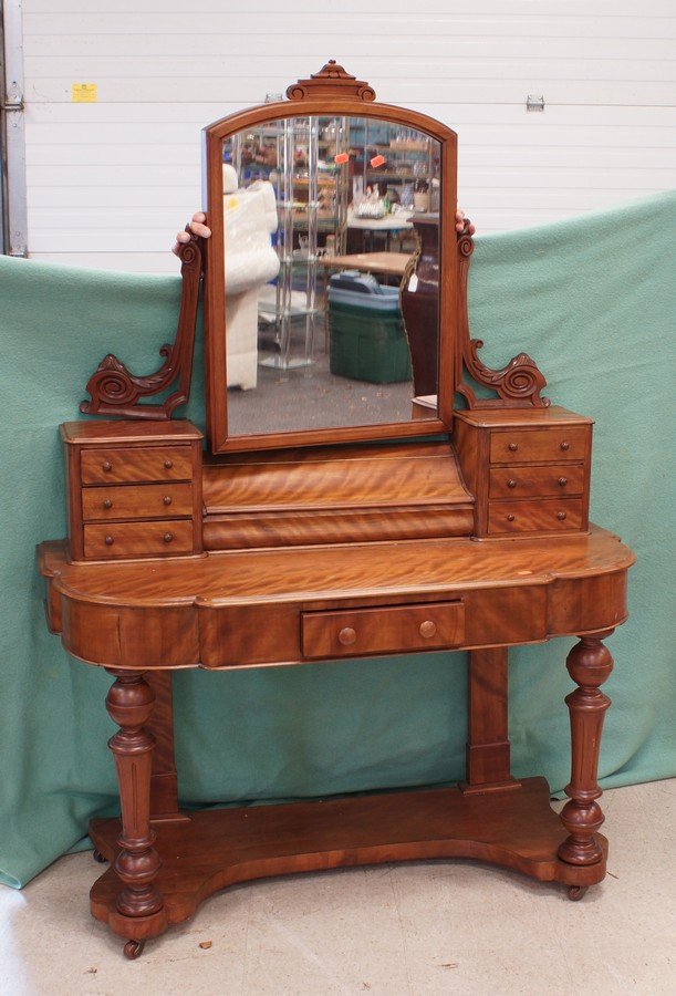 Carved figured fruitwood Victorian dressing table with: Carved figured fruitwood Victorian dressing table with swinging mirror, each side of top section with 3 drawers flanking a storage area with hinged lid, all raised on turned leg, 48" w x 67" h
