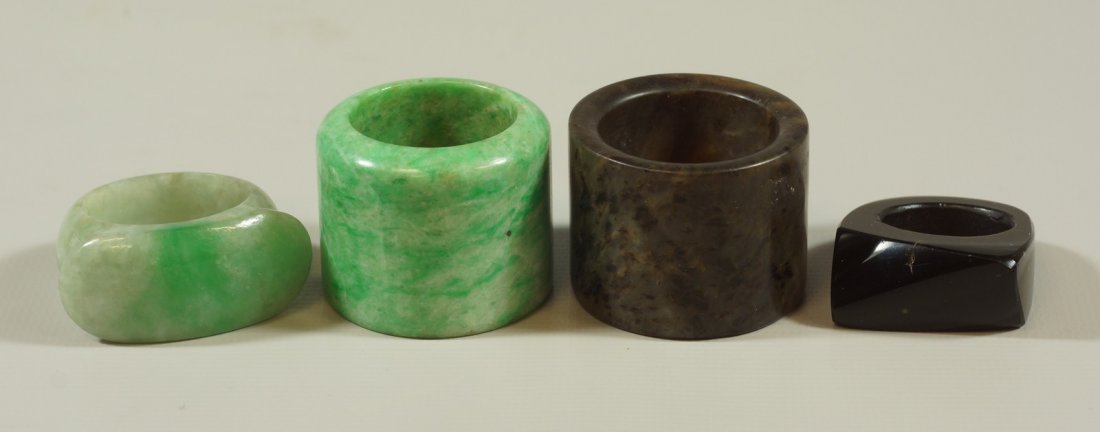 4 carved hard stone rings to include 2 archer's rings,: 4 carved hard stone rings to include 2 archer's rings, 1 saddle ring and a black stone ring, largest 7/8" high
